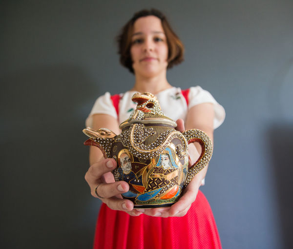 Woman holding japanese teapot
