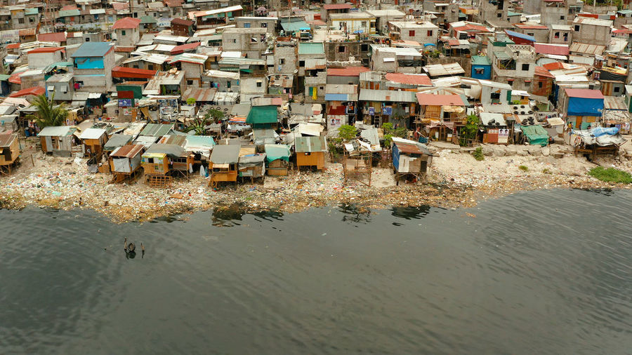 Poor district and slums in manila with shacks and buildings. manila, philippines.