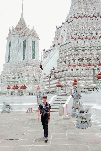 Full length of man walking against temple