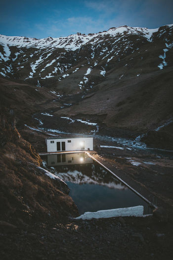 High angle view of swimming pool by built structure against snow covered landscape
