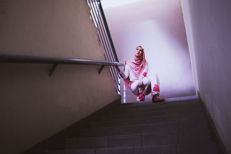 Low angle view of woman on steps