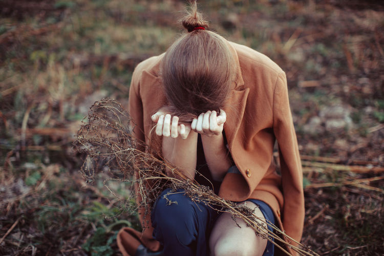 Depressed woman standing on farm