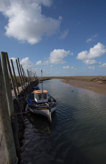 Boat moored on sea against sky