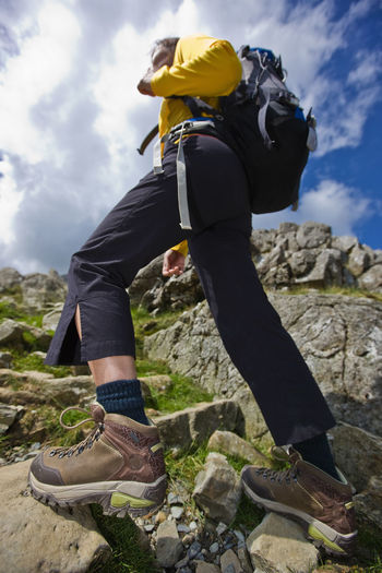 Woman hiking with rucksack low angle shot