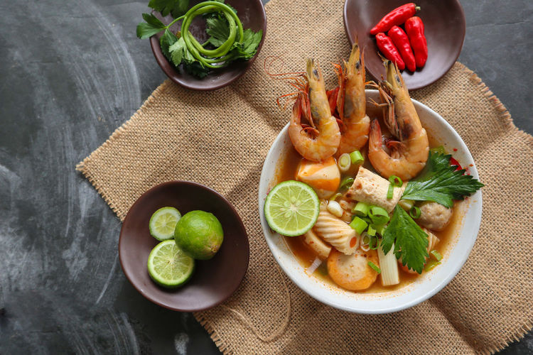 Tom yam soup originating from thailand. tom yum is made with shrimp, chili, lime, chicken, fish, 