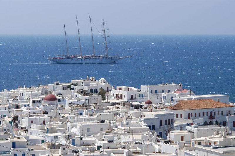 Sailing ship and townscape of mykonos island