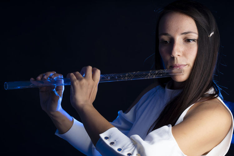 A beautiful girl that plays a crystal flute