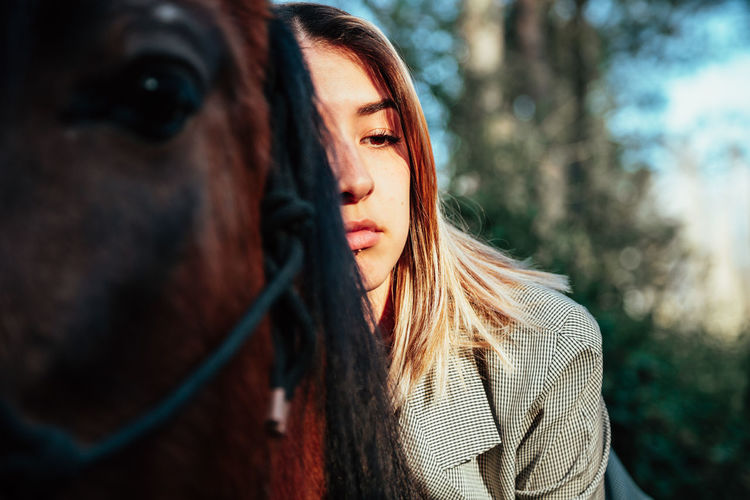 Woman with horse in forest