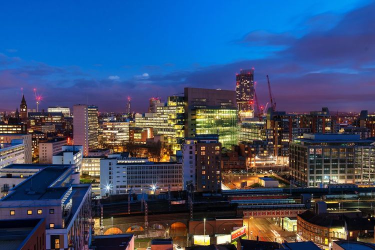 Illuminated cityscape against sky at night