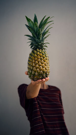 Close-up of pineapple against wall