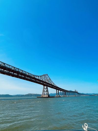 View of bridge over sea against clear sky