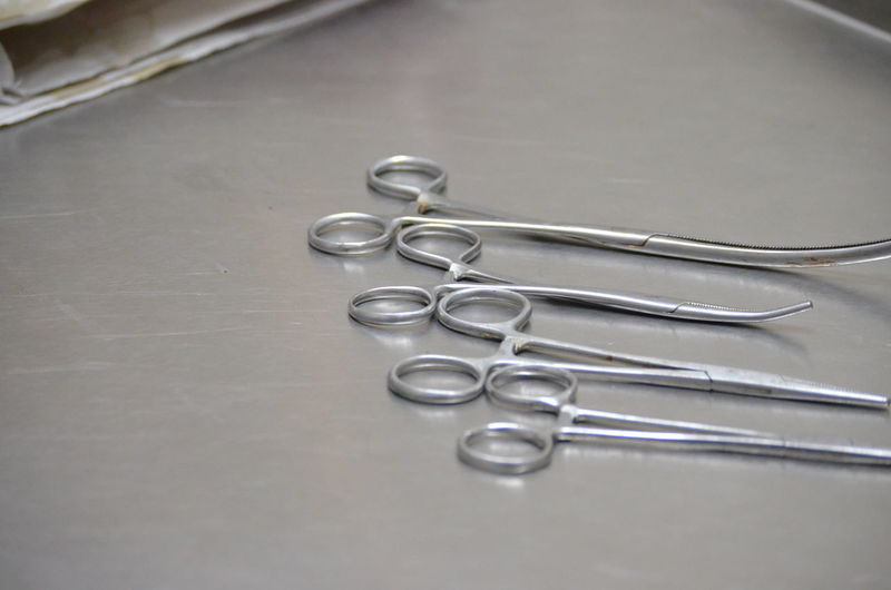 High angle view of surgical scissors on table at veterinary clinic