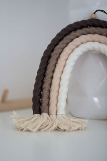 Close-up of rope on table against white background