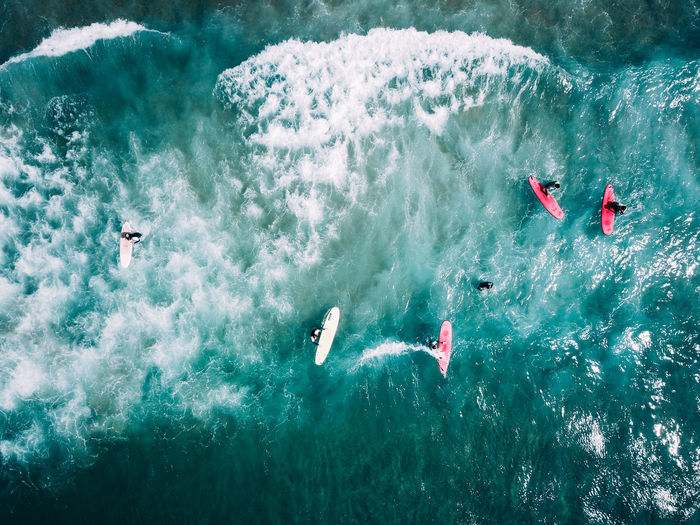 Aerial view of people surfing in sea