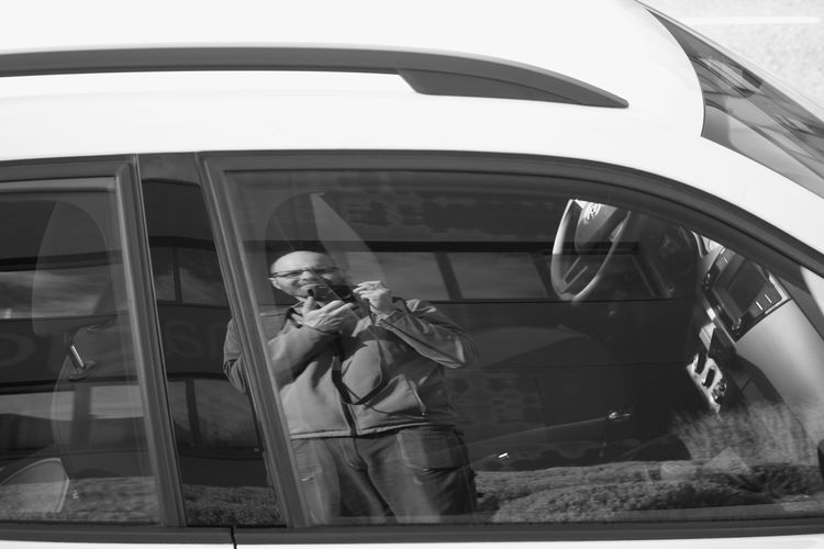 Man photographing through car window