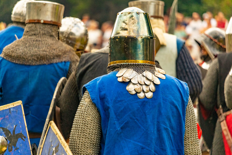 People wearing suit of armor while standing outdoors