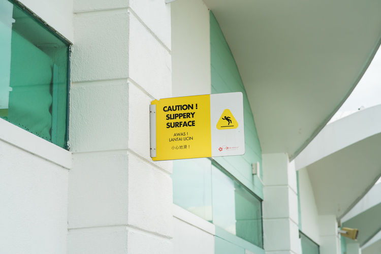 Low angle view of yellow sign on building
