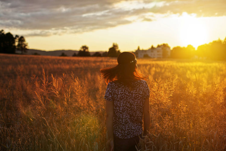 Rear view of woman looking at sunset