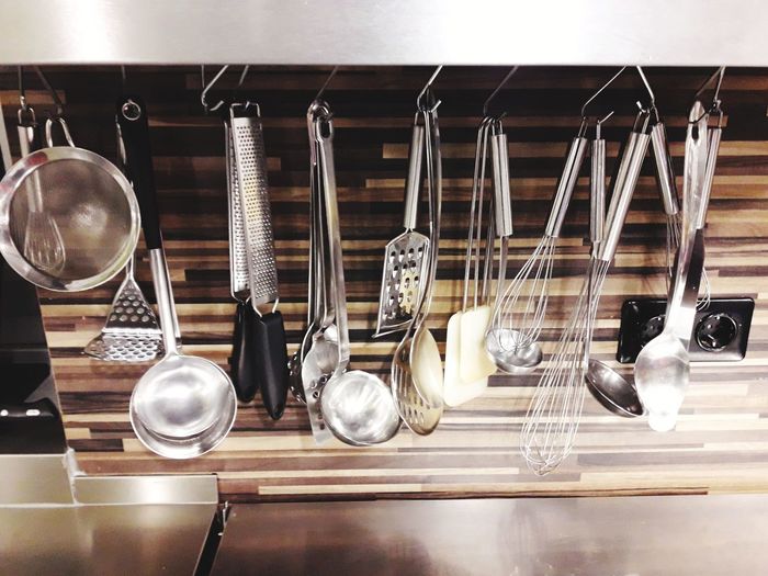 Close-up of kitchen utensils hanging on rack