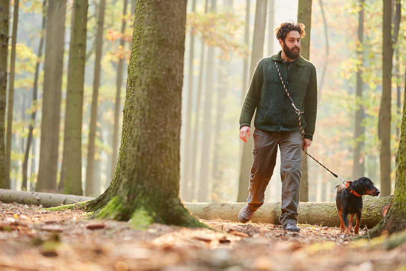 Man walking with dog in forest