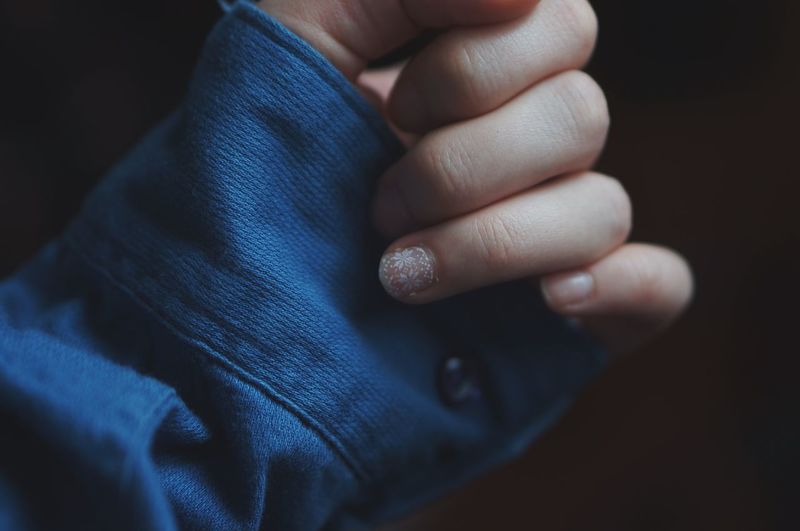 Cropped hand of child with nail paint