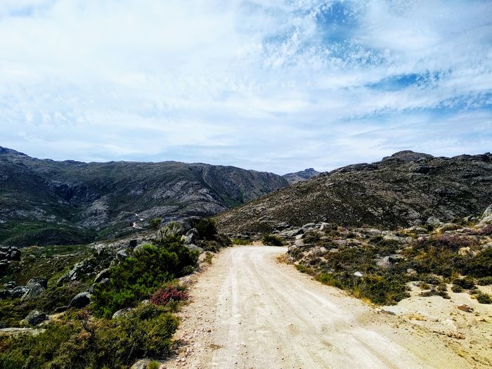 Road amidst mountains against sky