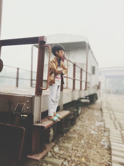 Boy standing on train
