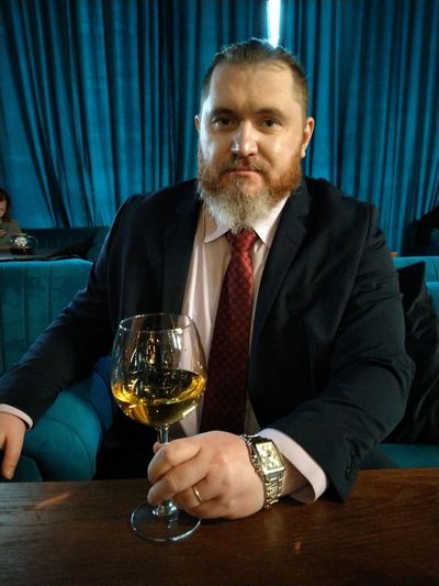 Portrait of businessman holding wineglass