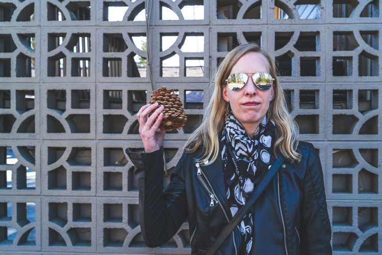 Portrait of smiling woman standing against built structure