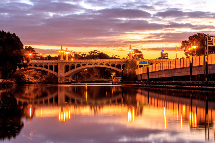 Church street bridge over yarra river reflection against sky during sunset