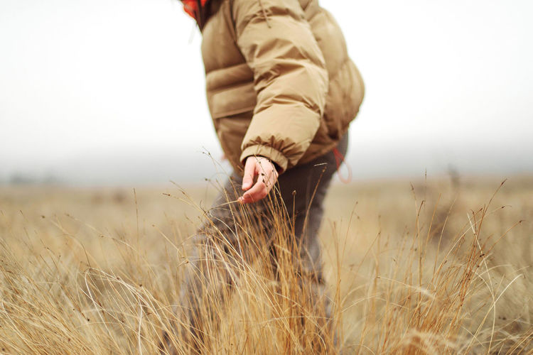 Unrecognizable female hands in autumn grass