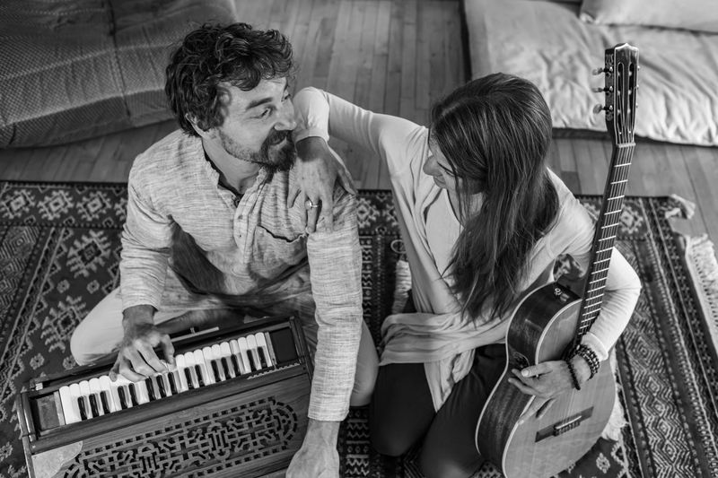Couple with harmonium and guitar sitting at home