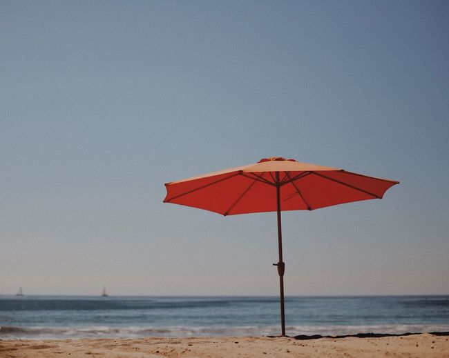Lifeguard hut on beach against clear sky