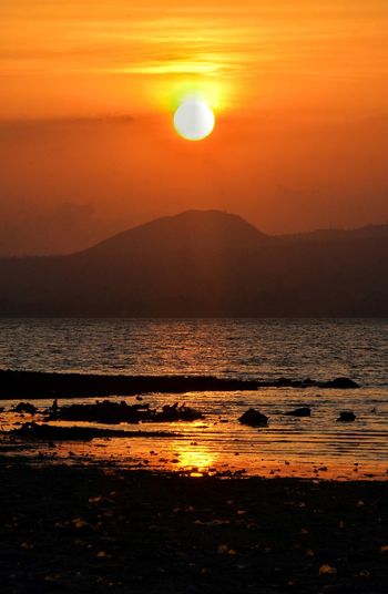Scenic view of sea against sky during sunset