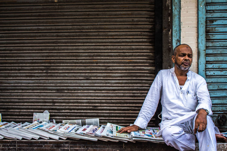 Man selling newspaper