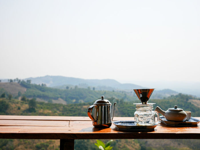 Tea cup on table against clear sky