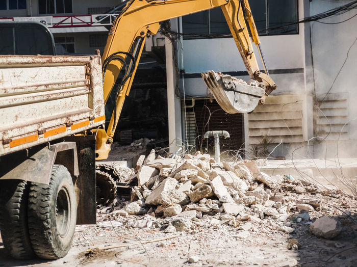 Bulldozer removes the debris from demolition on the construction site