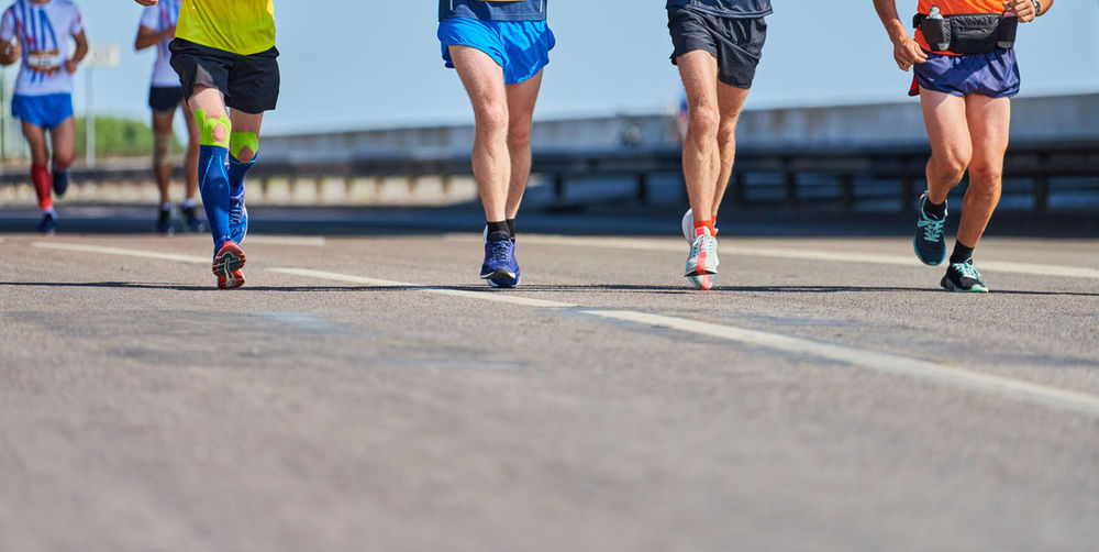 Low section of people running on street