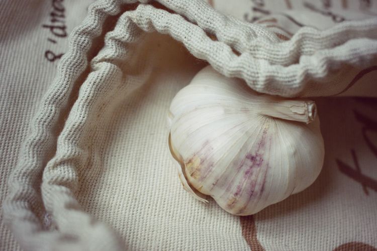 Close-up of garlic on fabric bag