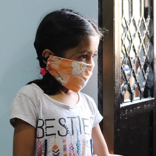 Close up of a little girl wearing corona mask