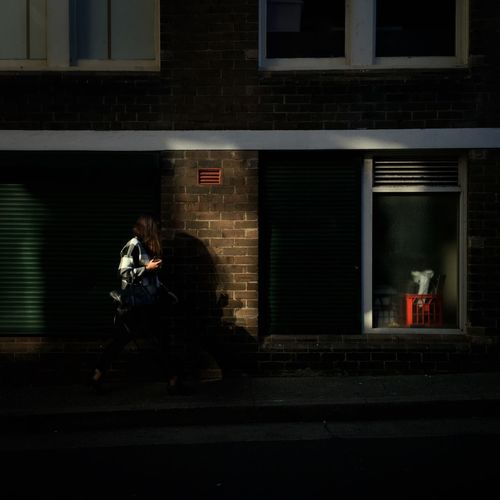 Full length of woman standing in front of building
