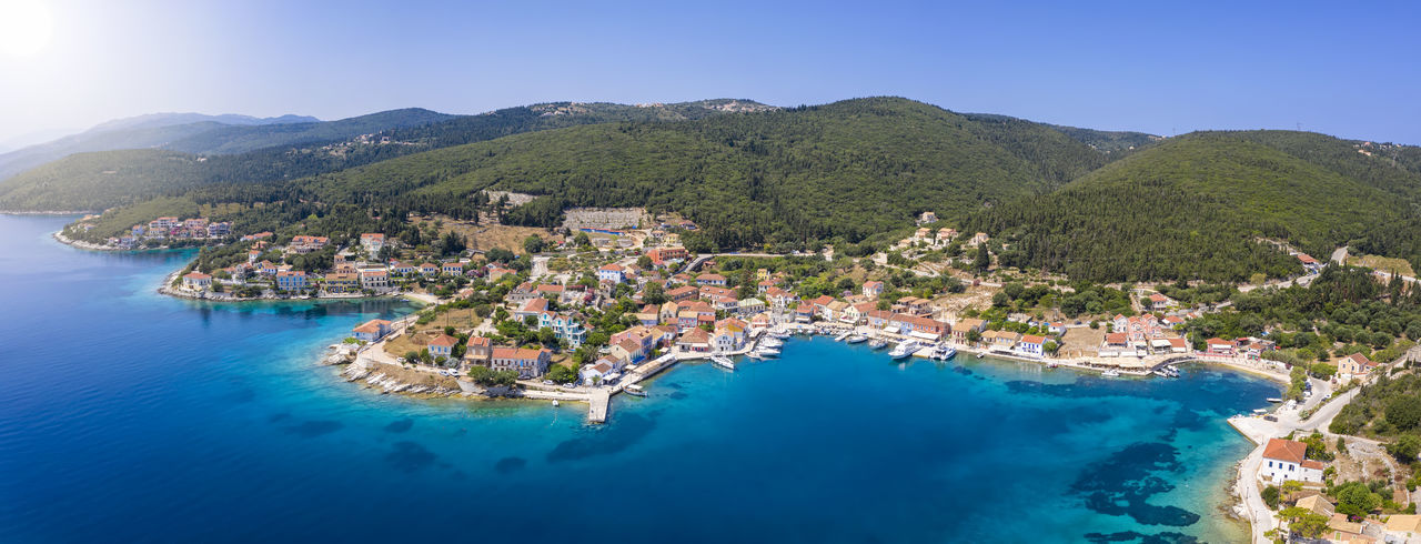 High angle view of city by sea against sky