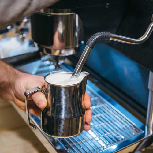 Cropped hand making coffee