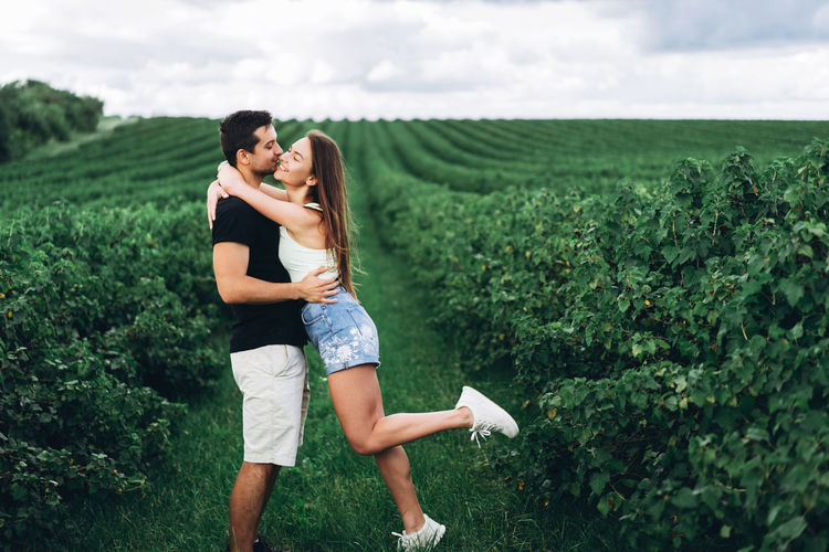 Couple kissing on field