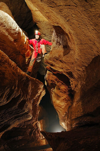 Low angle view of miner climbing on rock formation