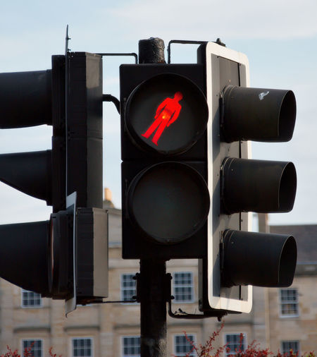Close-up of traffic signal against sky