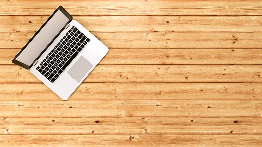 High angle view of laptop on wooden table