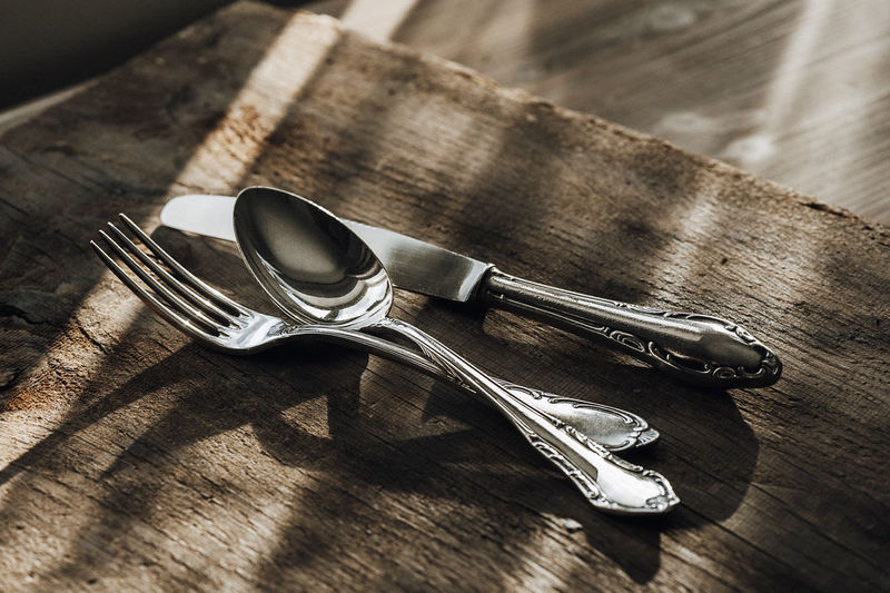 Close-up of eating utensils on table
