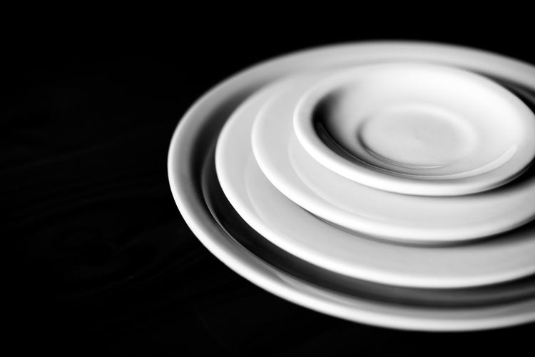 High angle view of empty coffee cup against black background