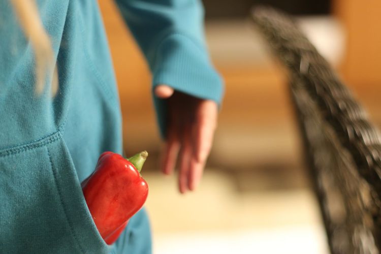 Close-up of woman holding red bell pepper